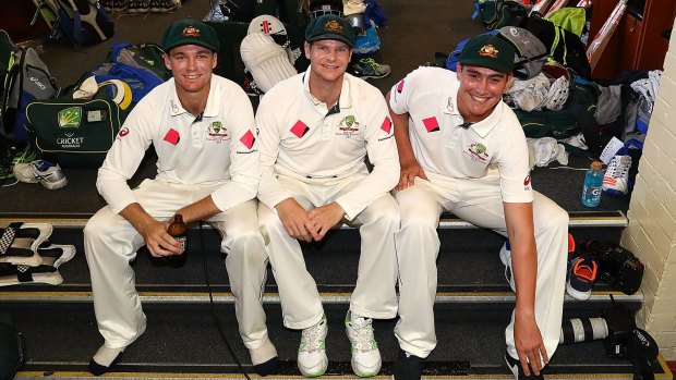 Winners are grinners: Trio Peter Handscomb, Steve Smith and Matt Renshaw inside Australia's dressing room at the SCG yesterday. 