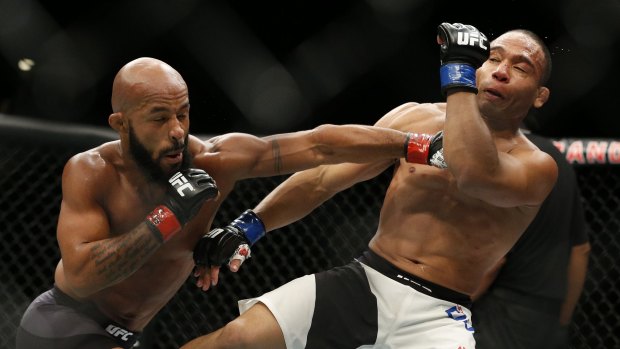 Demetrious Johnson hits John Dodson during their flyweight title mixed martial arts bout at UFC 191, Saturday.