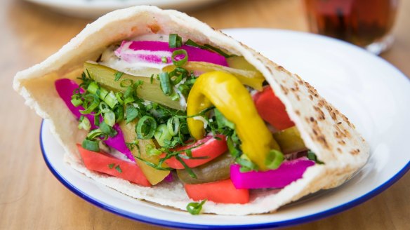 Pita filled with colourful pickles and falafel.
