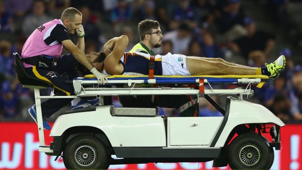 West Coast's Mitch Brown is taken from the ground after he injured his knee during the match against the Western Bulldogs on Saturday.