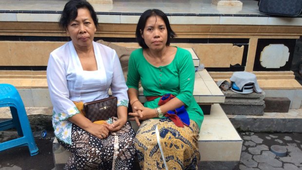 The wife of slain Bali police officer Wayan Sudarsa, Ketut Arsini (left) with her sister. 