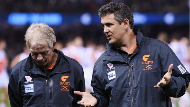 Rethink: Giants Leon Cameron (right) talks to his coaching staff after the loss.