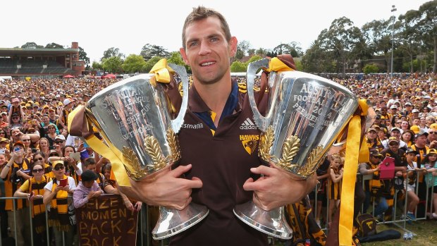 Luke Hodge with the club's past two premiership cups.