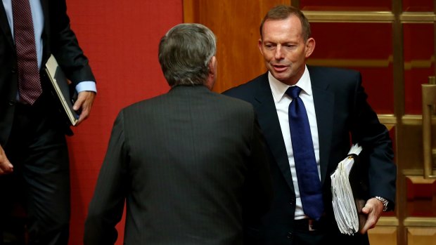 Former prime minister Tony Abbott congratulates Senator Bill Heffernan after the Senator delivered his valedictory speech earlier on Wednesday.