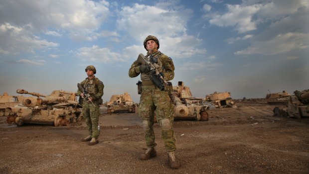 Private Brandon James, from Mooroopna in Victoria, and Private Corren Ints, from Morayfield in Queensland, on the ground at Camp Taji, north of Baghdad. 