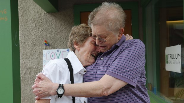 Marge Eide and Ann Sorrell, a couple for 43 years, embrace before exchanging vows in Ann Arbor, Michigan.