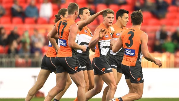 Cause for celebration: GWS players get around Jacob Hopper after he kicked a goal in the second term.