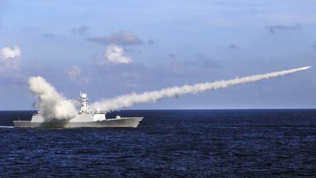 A Chinese missile frigate Yuncheng launches an anti-ship missile during a military exercise in the waters near China's Hainan Island.