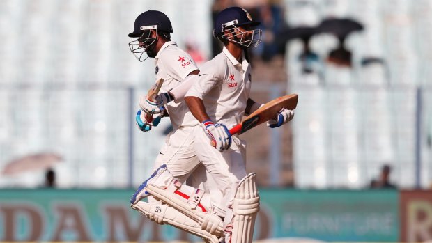 Mid-order fightback: Ajinkya Rahane and Cheteshwar Pujara take a single on the first day of the second Test match in Kolkata.