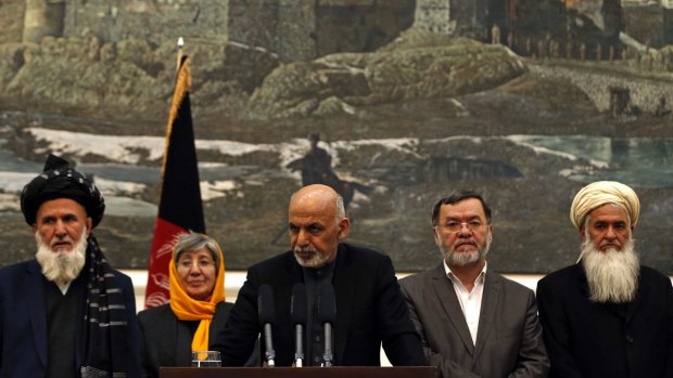 Afghan President Ashraf Ghani (centre) at a press conference in Kabul on December 10.