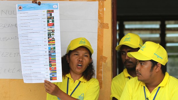 An electoral worker shows a ballot paper in Dili, East Timor, on Saturday.