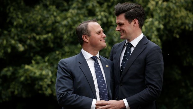 Liberal MP Tim Wilson poses for a portrait with his partner, Ryan Bolger, after Mr Wilson proposed.