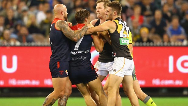 Flying the flag: Nathan Jones and Jack Viney tussle with Jack Riewoldt and Anthony Miles.