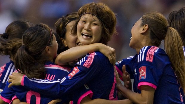 Japan's midfielder Mizuho Sakaguchi celebrates her goal against the Netherlands with teammates.