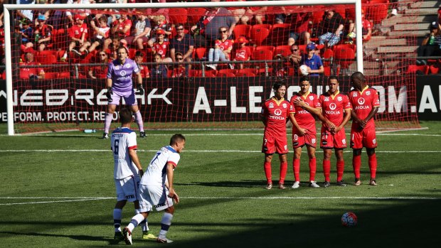 Bricking it: Adelaide players form a wall as Enver Alivodic prepares to take a free kick.