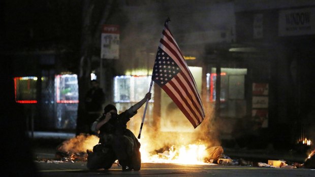 A demonstrator in Berkeley, where protests against police shootings turned violent on Monday night.