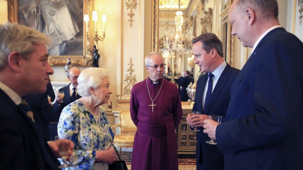 Queen Elizabeth, second left, speaks with British Prime Minister David Cameron, second right, as leader of the House of Commons Chris Grayling, right, and Archbishop of Canterbury Justin Welby, centre, watch during a reception in Buckingham Palace.