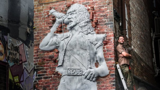 Bon Scott was honoured with a permanent sculpture coming out of the Cherry Bar brick wall.
