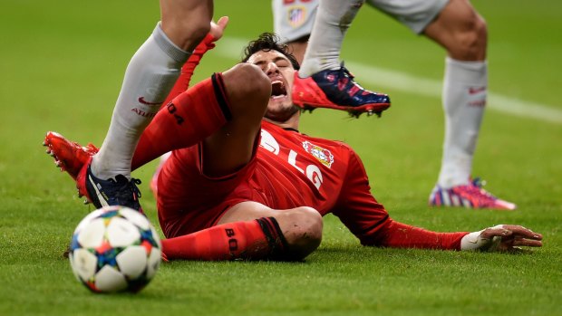 Leverkusen's goalscorer Hakan Calhanoglu vies for the ball.