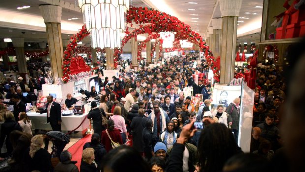 Black Friday masses: A crowd of shoppers hunt for bargains at Macy's 