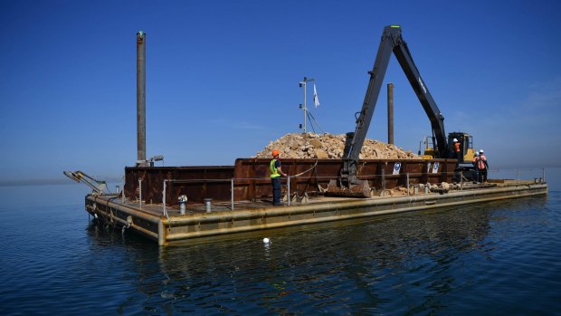 A 20-metre barge loaded with limestone rubble to be planted on the sea bed as part of Victoria's largest reef restoration project in Hobsons Bay and Corio Bay. 