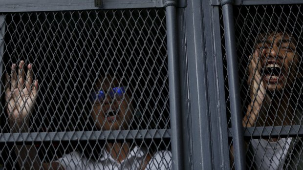 Demonstrators shout from a police van after they were detained in Kuala Lumpur last week.