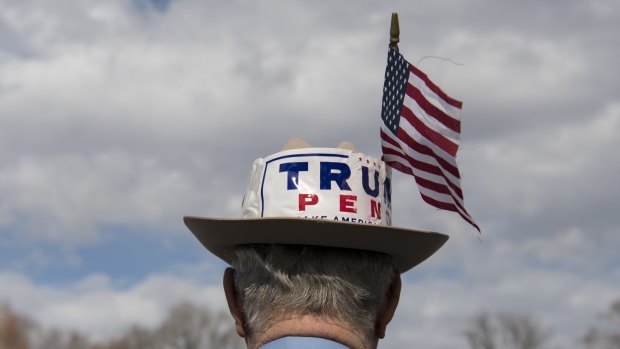 A visitor to Washington DC wears a hat with Donald Trump and US Vice-President-elect Mike Pence's names on just days before Trump's swearing in as American president.