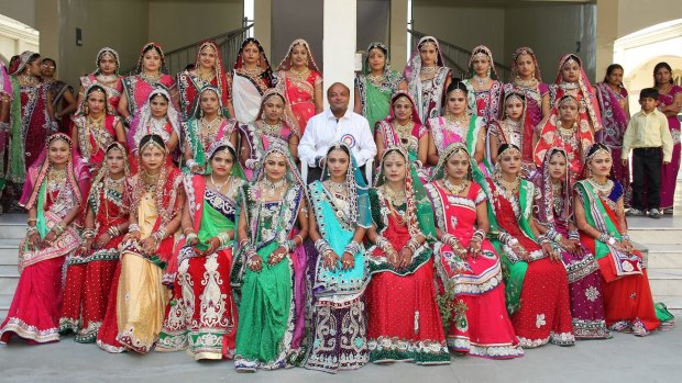 Mahesh Savani with brides during a wedding event in 2014. 