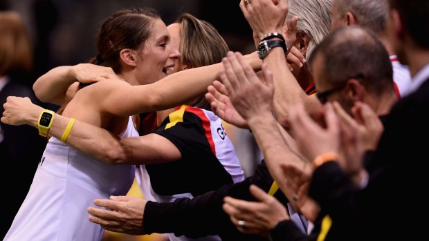 Relief:  Andrea Petkovic of Germany celebrates with teammates after defeating Stosur.