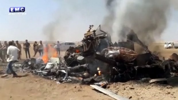 Image purporting to show people gathered around the burning wreckage of a Russian helicopter downed in Syria on Monday.