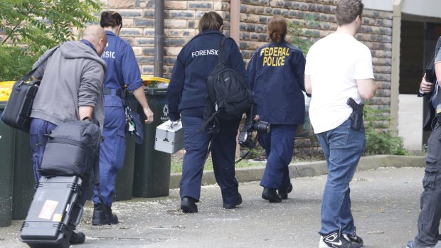 Police search a house in Wentworthville. 