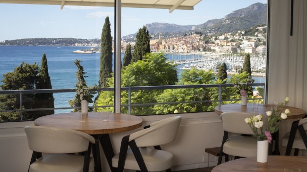 Mirazur's large windows frame a postcard view of Menton's colourful old town cascading towards the harbour.