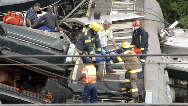 Rescue workers carry an injured man from the wreckage of a luxury passenger train that crashed in Pretoria in 2010. Train collisions and derailments are not uncommon in South Africa.