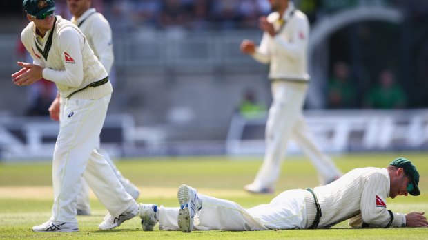 Tough match: Michael Clarke lies grounded after spilling a catch from Ian Bell at second slip.