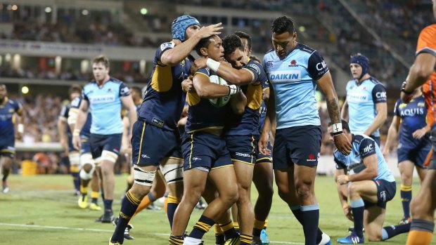Ready for the international arena: Christian Lealiifano is congratulated by teammates after scoring a try for the Brumbies.