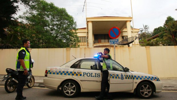 Police officers guard outside the North Korean Embassy in Kuala Lumpur.