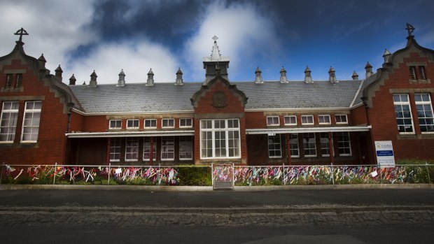 The old St Alipius Boys School is now a kindergarten with ribbons tied to the fence to pay tribute to the victims and survivors of child abuse.