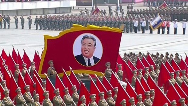 A portrait of the country's founder Kim Il-sung is carried during a parade in Pyongyang on Saturday.