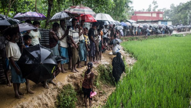 Rohingya refugees queue for hours, waiting for an aid distribution, in Bangladesh.