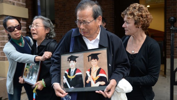 Devastated: Relatives of victims allegedly murdered by Robert Xie express their grief after giving evidence in May.