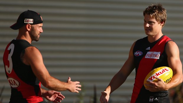 MELBOURNE, AUSTRALIA - MARCH 04:  Clinton Jones of the Bombers speaks with Paul Chapman during an Essendon Bombers AFL training session at True Value Solar Centre on March 4, 2015 in Melbourne, Australia.  (Photo by Robert Cianflone/Getty Images)