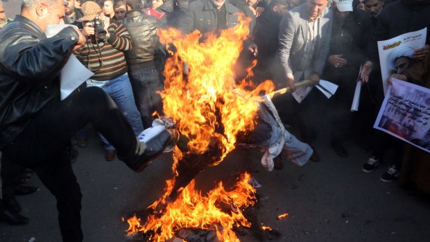 Followers of Shiite cleric Muqtada al-Sadr burn an effigy of King Salman of Saudi Arabia in Baghdad, Iraq. 