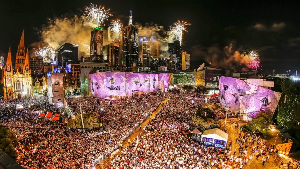 Bang for their buck: Crowds enjoy the fireworks from Federation Square on New Year's Eve 2016.