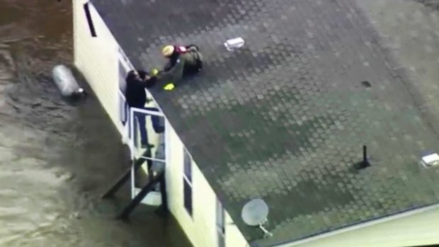 A man is rescued from a flooded home in Pinetops, North Carolina.