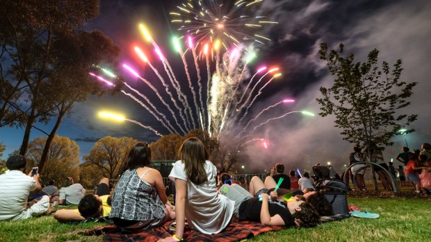 Lighting up the city: families watch the fireworks in Melbourne on New Year's Eve 2015.