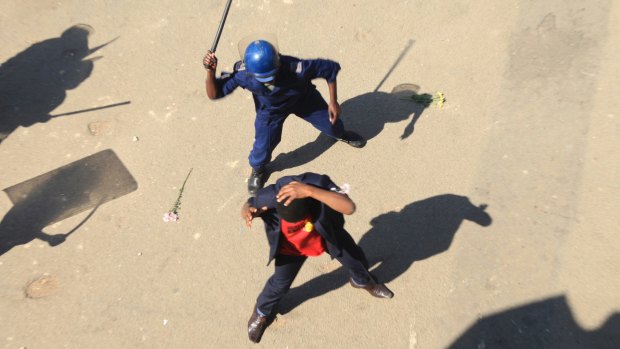 Zimbabwean riot police clash with protesters in Harare during a demonstration against the introduction of bond notes by the Reserve Bank of Zimbabwe.