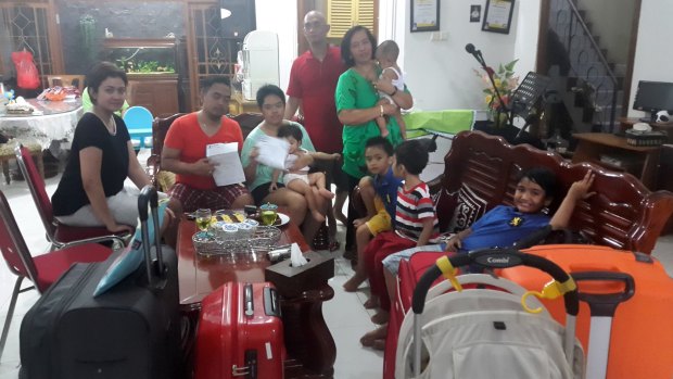 Lucky escape: Christianawati, her husband Ari Putro Cahyono and their extended family after missing flight QZ8501.