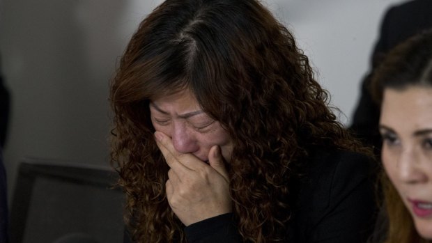 Michelle Leng's mother Mei Zhang breaks down while talking to media in Sydney.