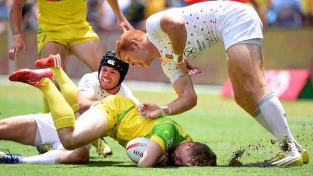 Face plant: Henry Hutchison of Australia is tackled by Tom Bowen and James Rodwellin in Sydney.