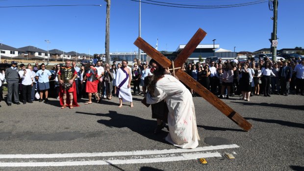 Thousands watch the Stations of the Cross re-enactment in Punchbowl.